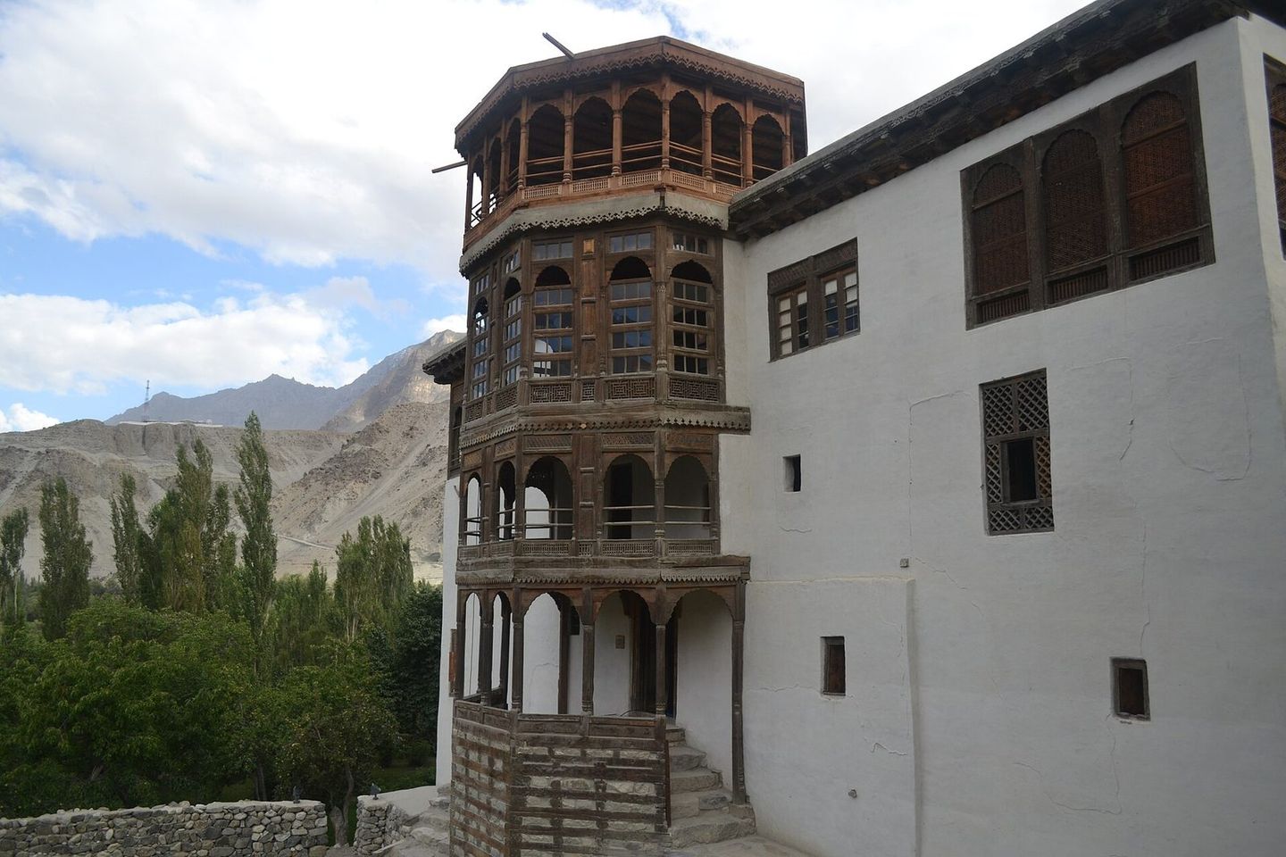 The white walls and carved wooden balcony tower of Khaplu Palace