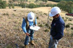 Figure 1 - View to the South East as Dr. Vladimir David records the collar coordinates for Hole #1 with GPS unit