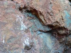 Plate 8. Example of Copper carbonate mineralisation (malachite) above portal entrance.