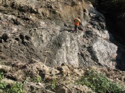 Worker washing down the newly excavated pegmatite structure located south of the North Aubry prospect to enable the geological team to review and identify the various lithium mineralisation zones.