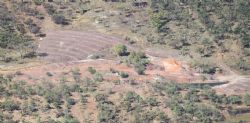 Figure 5: Iron Blow aerial view (2011) looking east showing low grade stockpile and historic open-pit