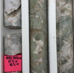 Coarse green spodumene comprising up to 30%-40% of the pegmatite.
