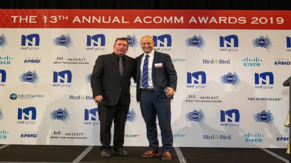 Hamish Lee, VP Sales APAC, Speedcast, receiving the ACOMMS award