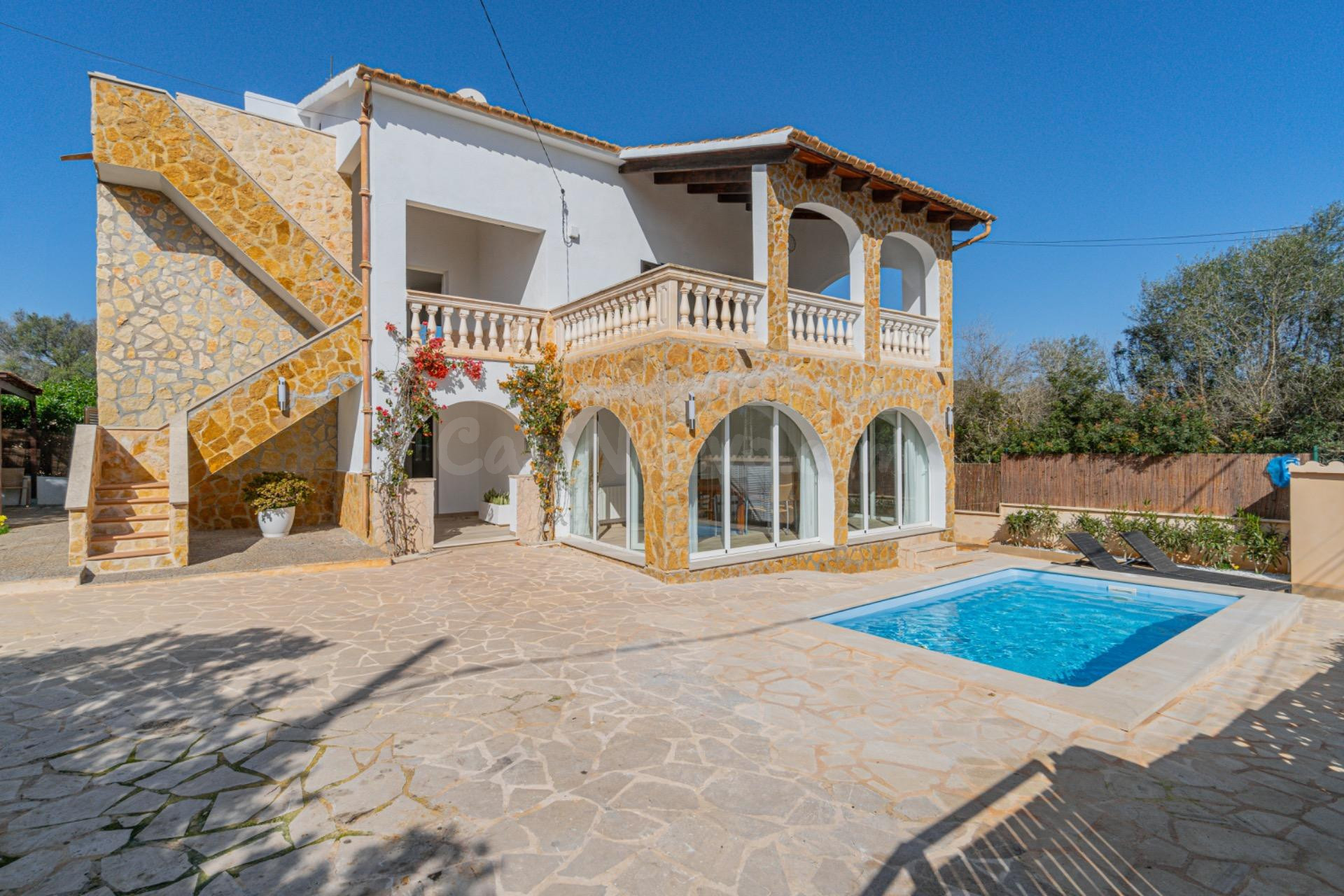 Chalet con dos apartamentos en Cala Santanyi con jardín y piscina