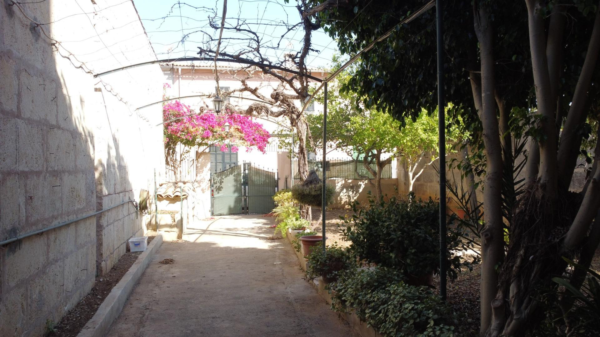 Auténtica casa mallorquina con jardín, amplios garajes y gran potencial en Santa Margalida