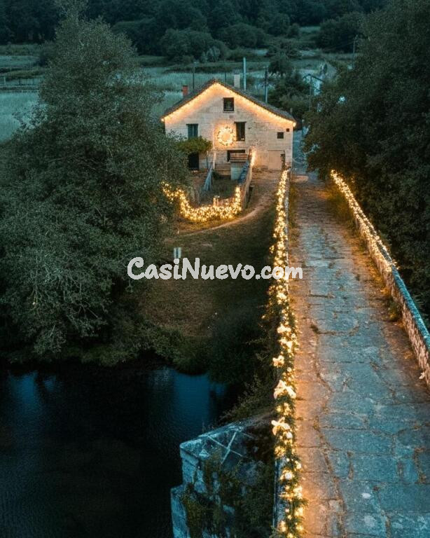Casa de piedra reformada con jardín frente al puente romano de Cernadela (Mondariz)