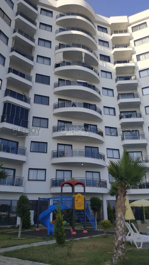 Меблированная квартира на 1-м этаже в доме 2022 года постройки, в 600 метрах от моря, в современном районе Аланьи - Махмутлар в Турции - фото 1