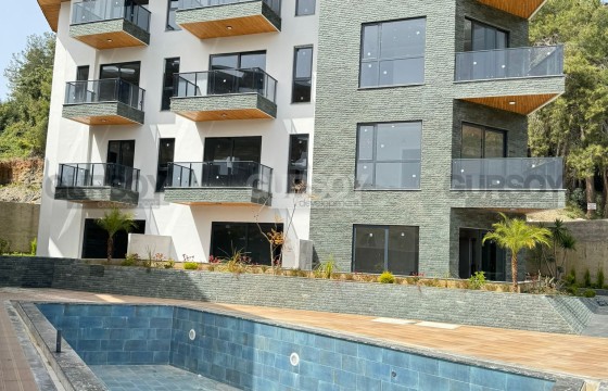 Стильная двухкомнатная квартира в новом комплексе в Хасбахче в Турции - фото 11