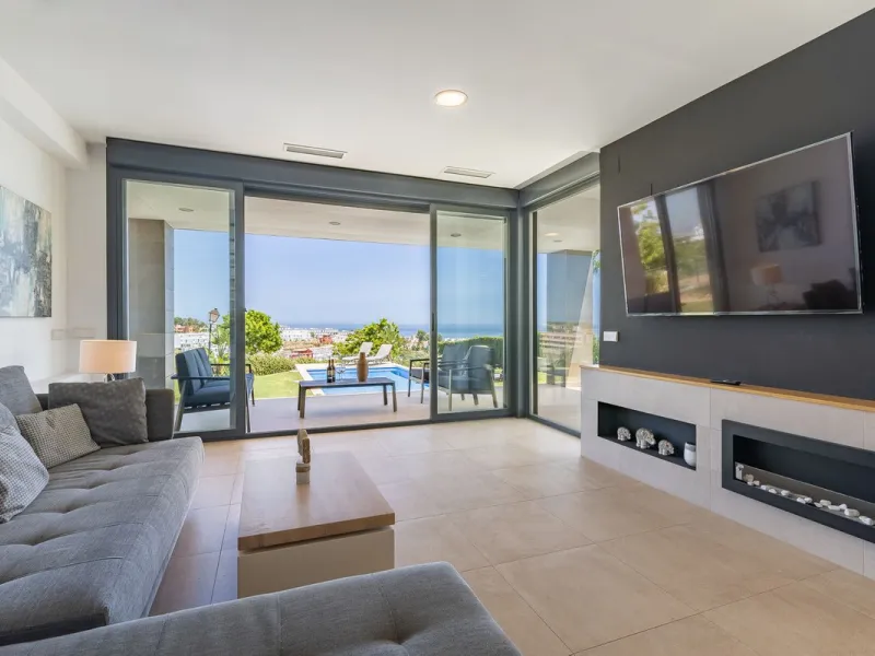 This stunning two-story villa boasts four spacious bedrooms, each with fitted wardrobes, electric blinds, and individual air conditioning control. The three elegant bathrooms feature the comfort of underfloor heating.