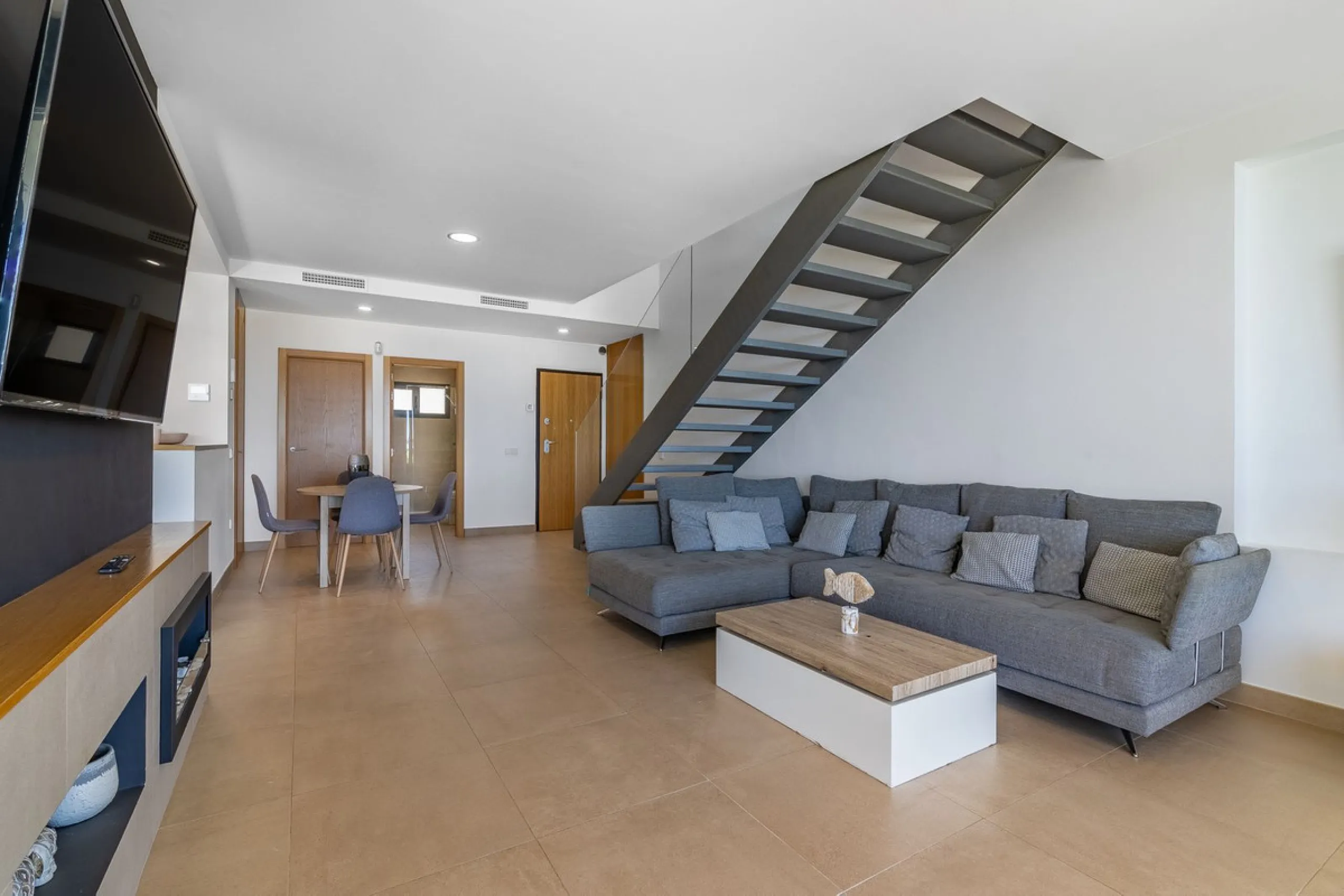 This stunning two-story villa boasts four spacious bedrooms, each with fitted wardrobes, electric blinds, and individual air conditioning control. The three elegant bathrooms feature the comfort of underfloor heating.