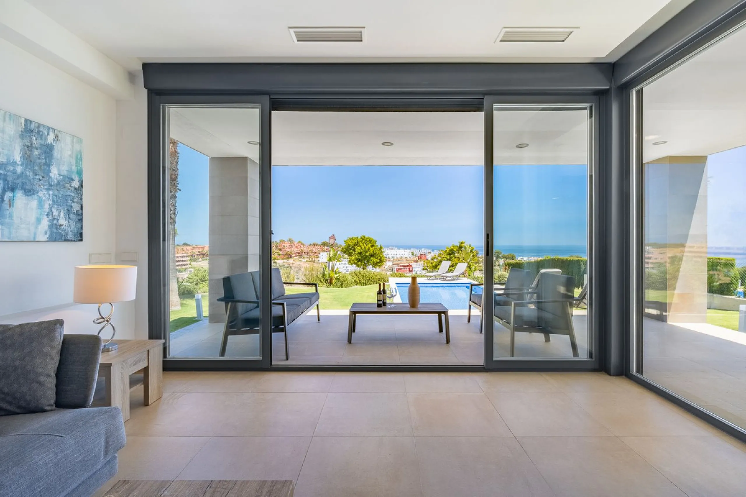This stunning two-story villa boasts four spacious bedrooms, each with fitted wardrobes, electric blinds, and individual air conditioning control. The three elegant bathrooms feature the comfort of underfloor heating.