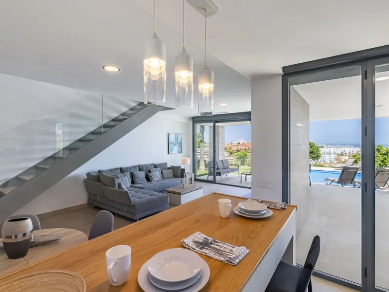 This stunning two-story villa boasts four spacious bedrooms, each with fitted wardrobes, electric blinds, and individual air conditioning control. The three elegant bathrooms feature the comfort of underfloor heating.