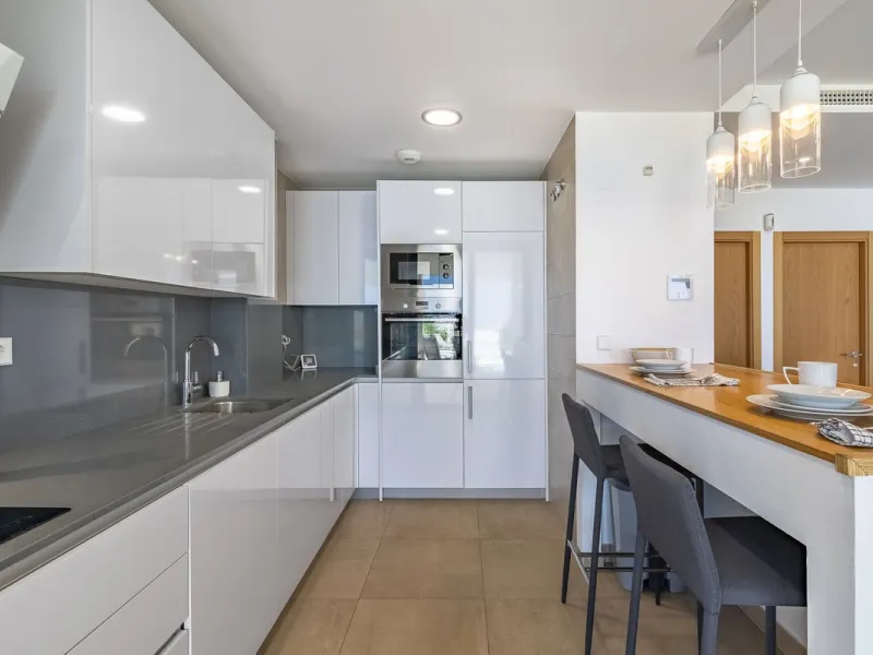 This stunning two-story villa boasts four spacious bedrooms, each with fitted wardrobes, electric blinds, and individual air conditioning control. The three elegant bathrooms feature the comfort of underfloor heating.