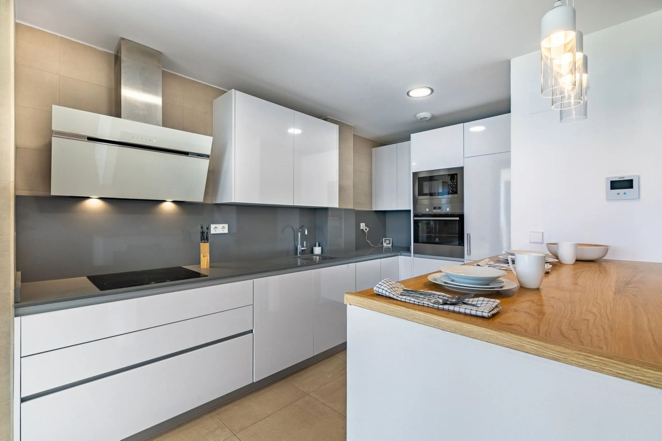 This stunning two-story villa boasts four spacious bedrooms, each with fitted wardrobes, electric blinds, and individual air conditioning control. The three elegant bathrooms feature the comfort of underfloor heating.