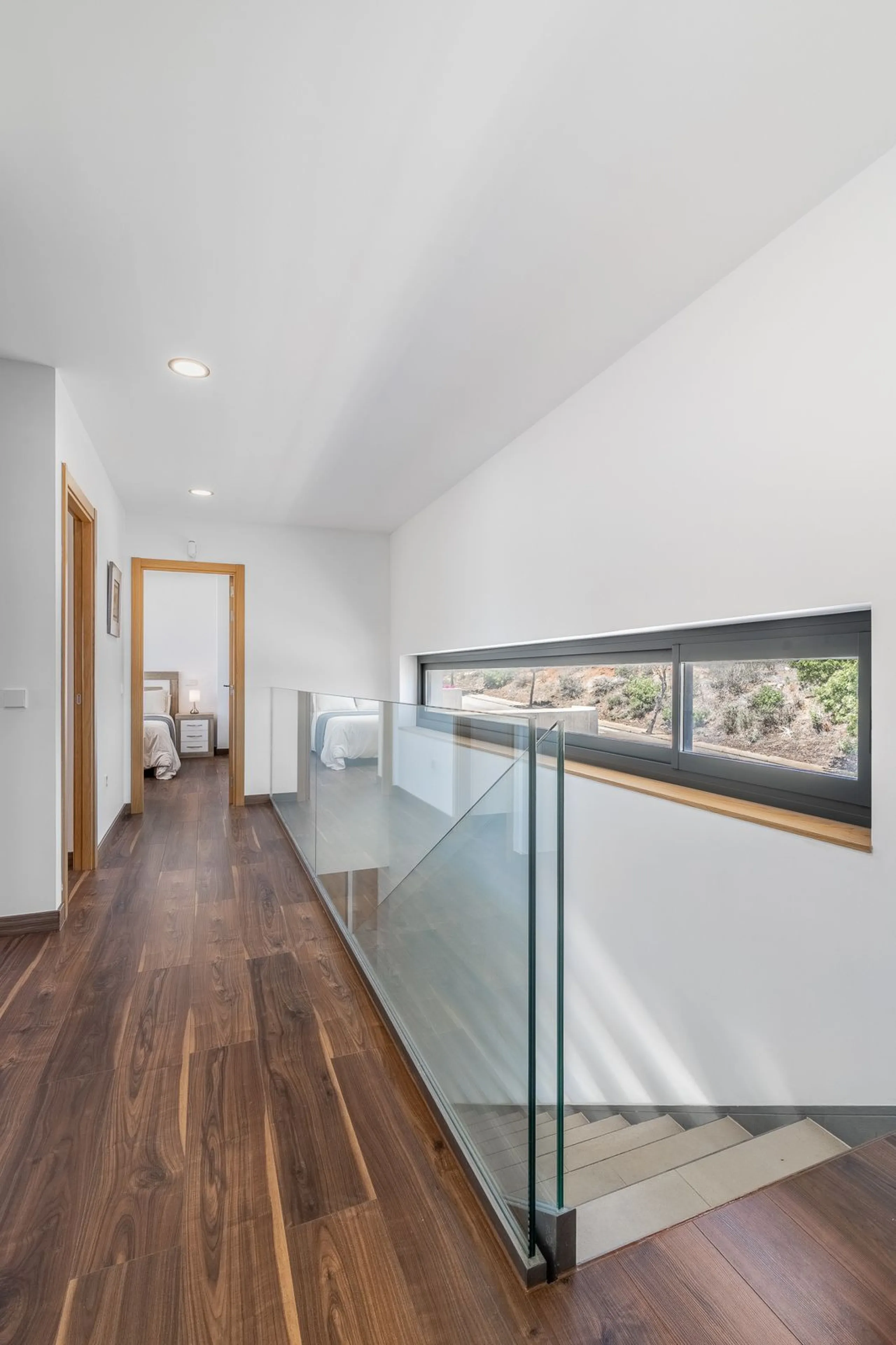 This stunning two-story villa boasts four spacious bedrooms, each with fitted wardrobes, electric blinds, and individual air conditioning control. The three elegant bathrooms feature the comfort of underfloor heating.