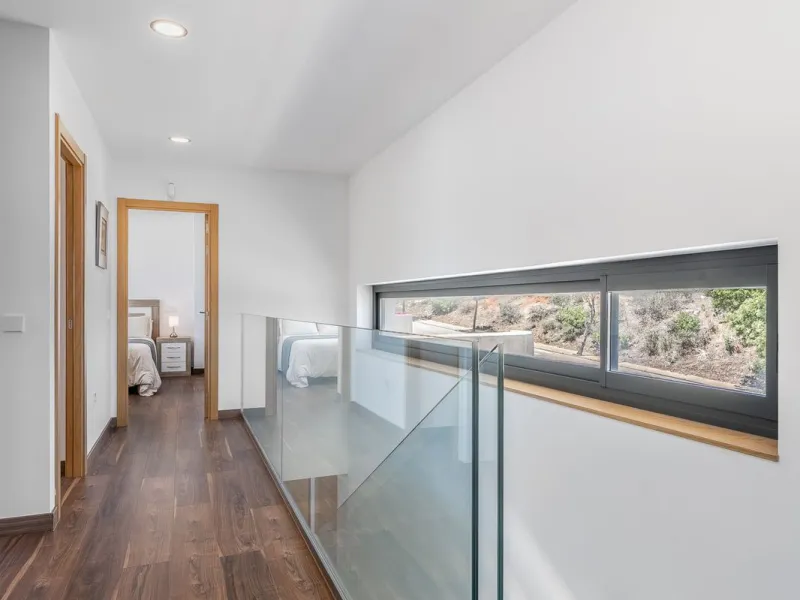 This stunning two-story villa boasts four spacious bedrooms, each with fitted wardrobes, electric blinds, and individual air conditioning control. The three elegant bathrooms feature the comfort of underfloor heating.