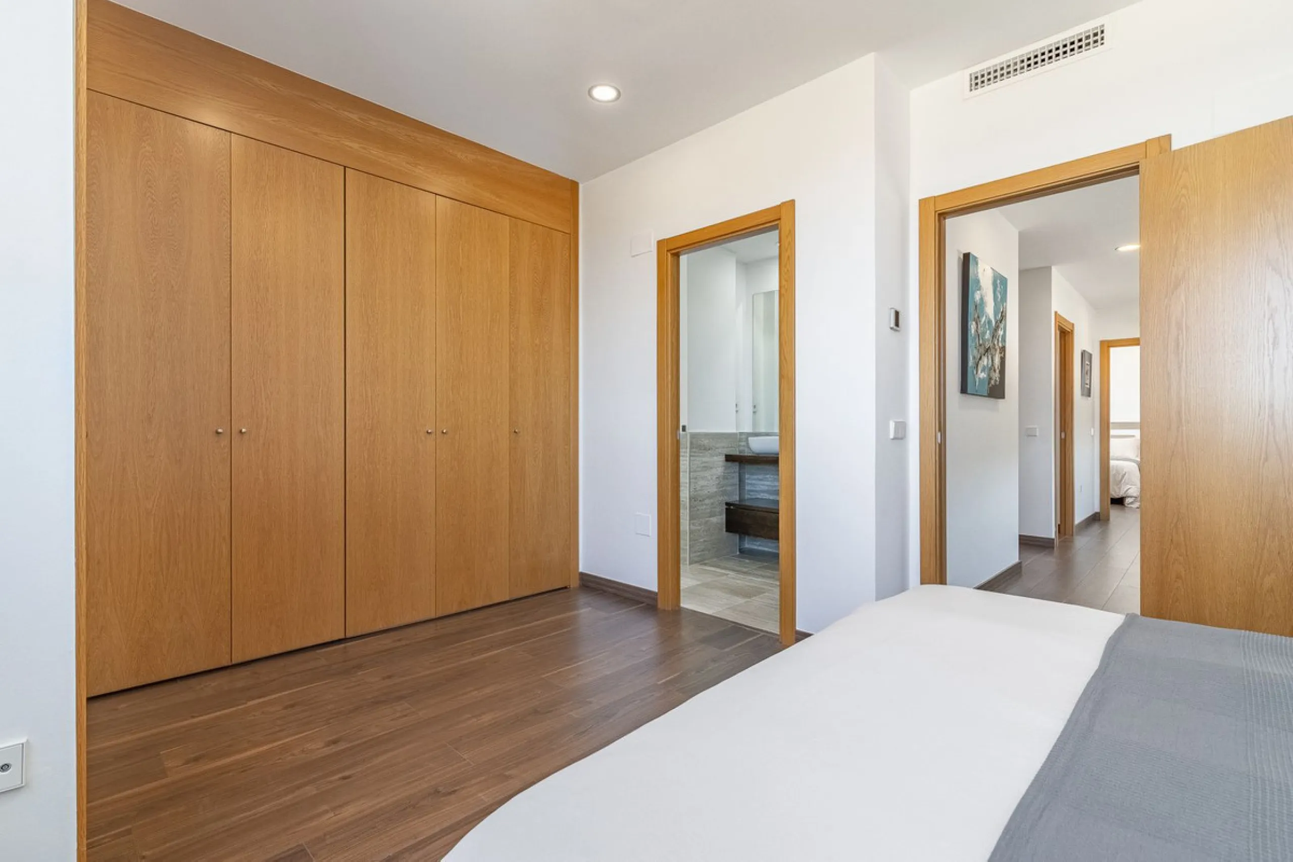 This stunning two-story villa boasts four spacious bedrooms, each with fitted wardrobes, electric blinds, and individual air conditioning control. The three elegant bathrooms feature the comfort of underfloor heating.
