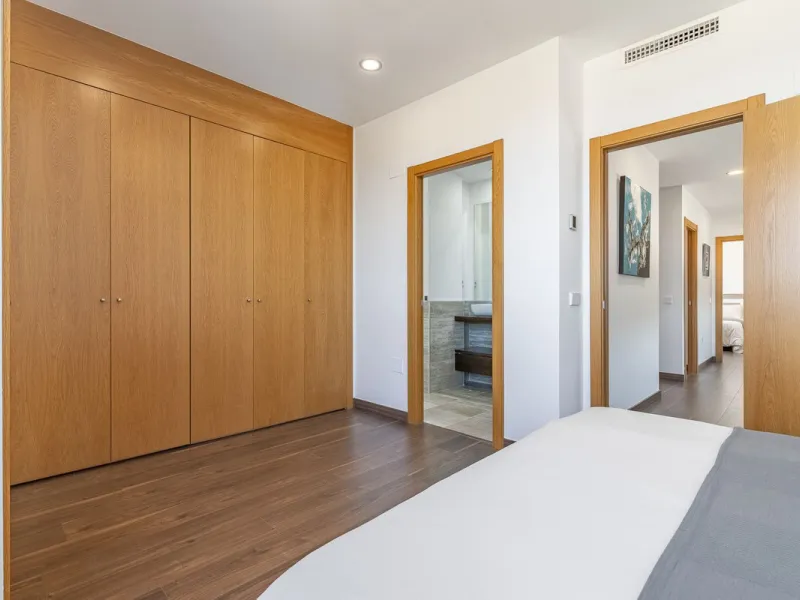This stunning two-story villa boasts four spacious bedrooms, each with fitted wardrobes, electric blinds, and individual air conditioning control. The three elegant bathrooms feature the comfort of underfloor heating.
