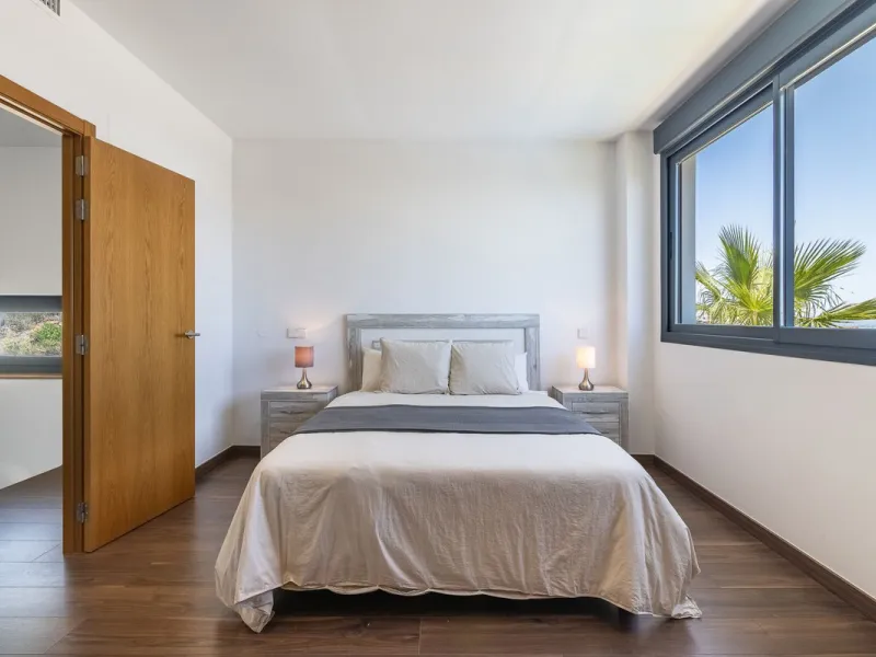This stunning two-story villa boasts four spacious bedrooms, each with fitted wardrobes, electric blinds, and individual air conditioning control. The three elegant bathrooms feature the comfort of underfloor heating.