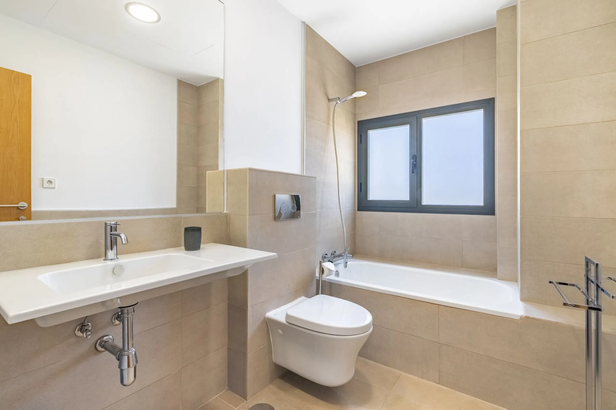 This stunning two-story villa boasts four spacious bedrooms, each with fitted wardrobes, electric blinds, and individual air conditioning control. The three elegant bathrooms feature the comfort of underfloor heating.