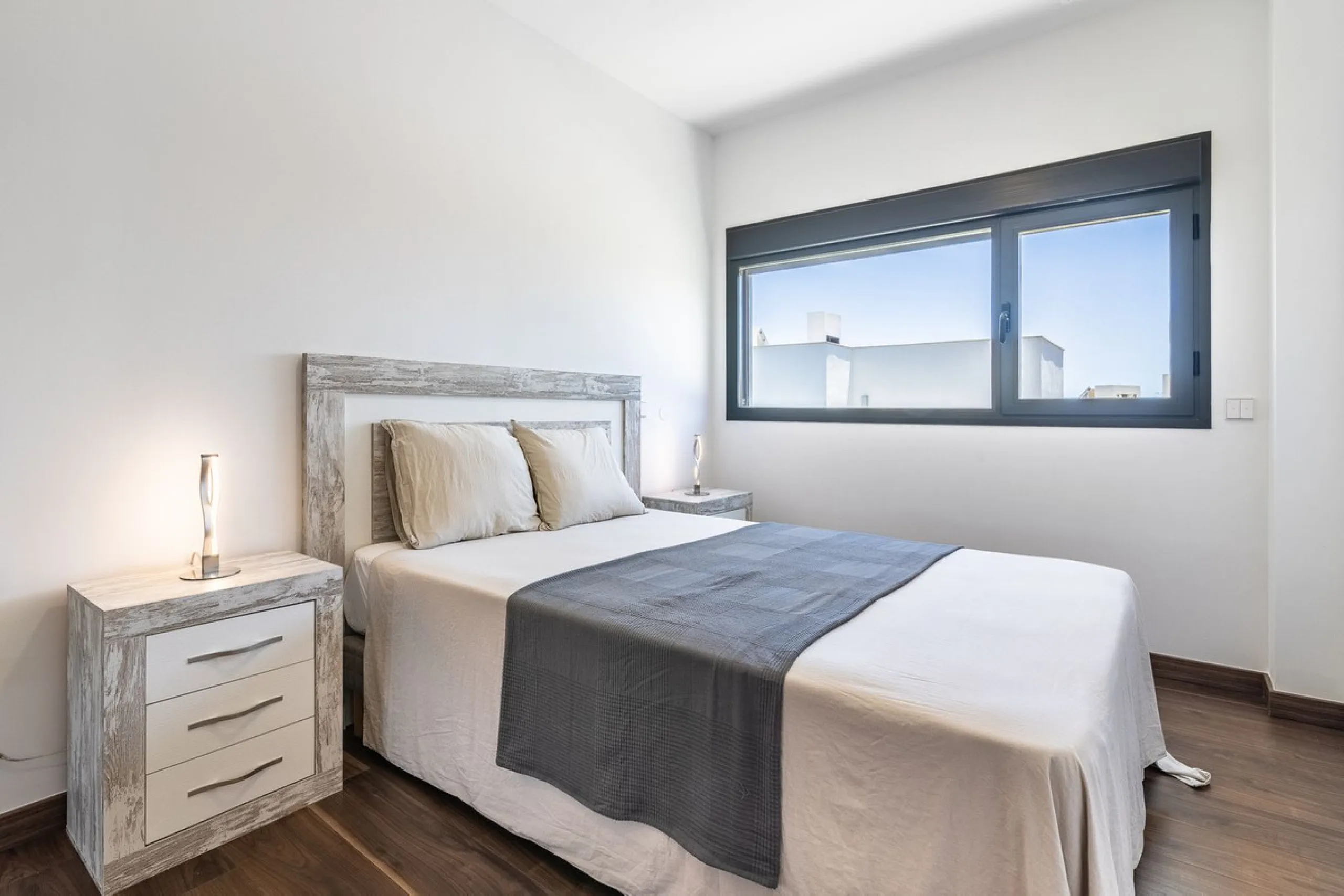This stunning two-story villa boasts four spacious bedrooms, each with fitted wardrobes, electric blinds, and individual air conditioning control. The three elegant bathrooms feature the comfort of underfloor heating.