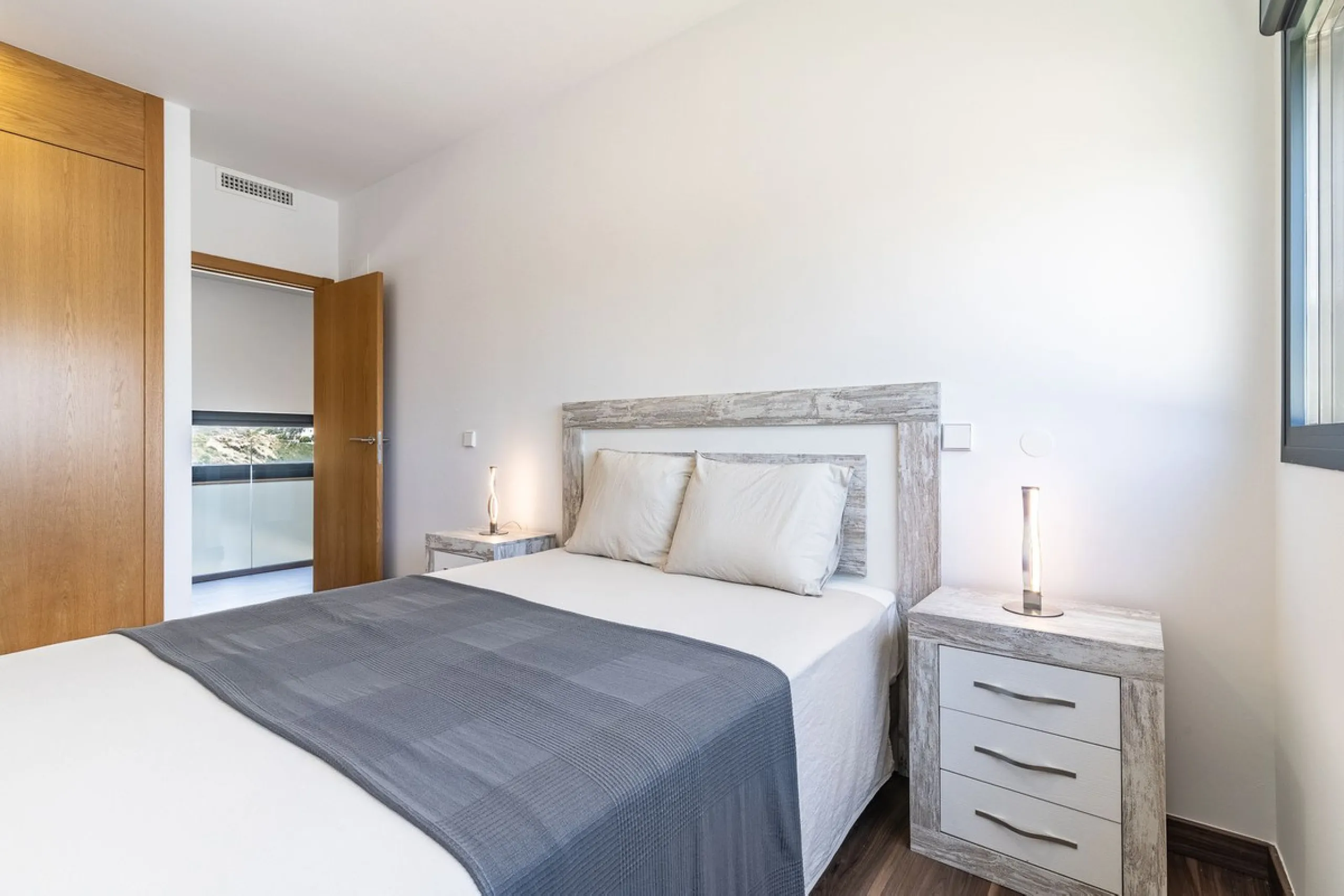 This stunning two-story villa boasts four spacious bedrooms, each with fitted wardrobes, electric blinds, and individual air conditioning control. The three elegant bathrooms feature the comfort of underfloor heating.
