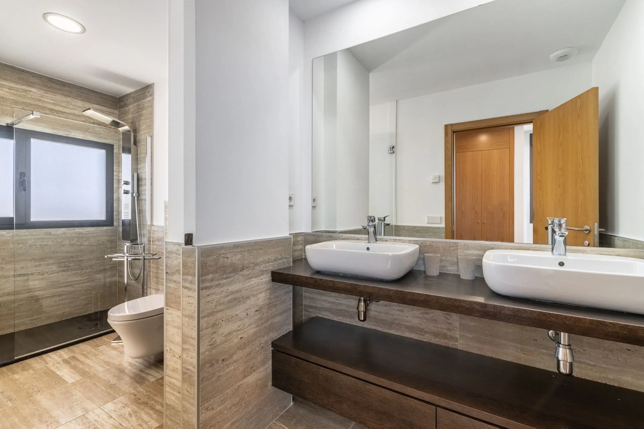 This stunning two-story villa boasts four spacious bedrooms, each with fitted wardrobes, electric blinds, and individual air conditioning control. The three elegant bathrooms feature the comfort of underfloor heating.