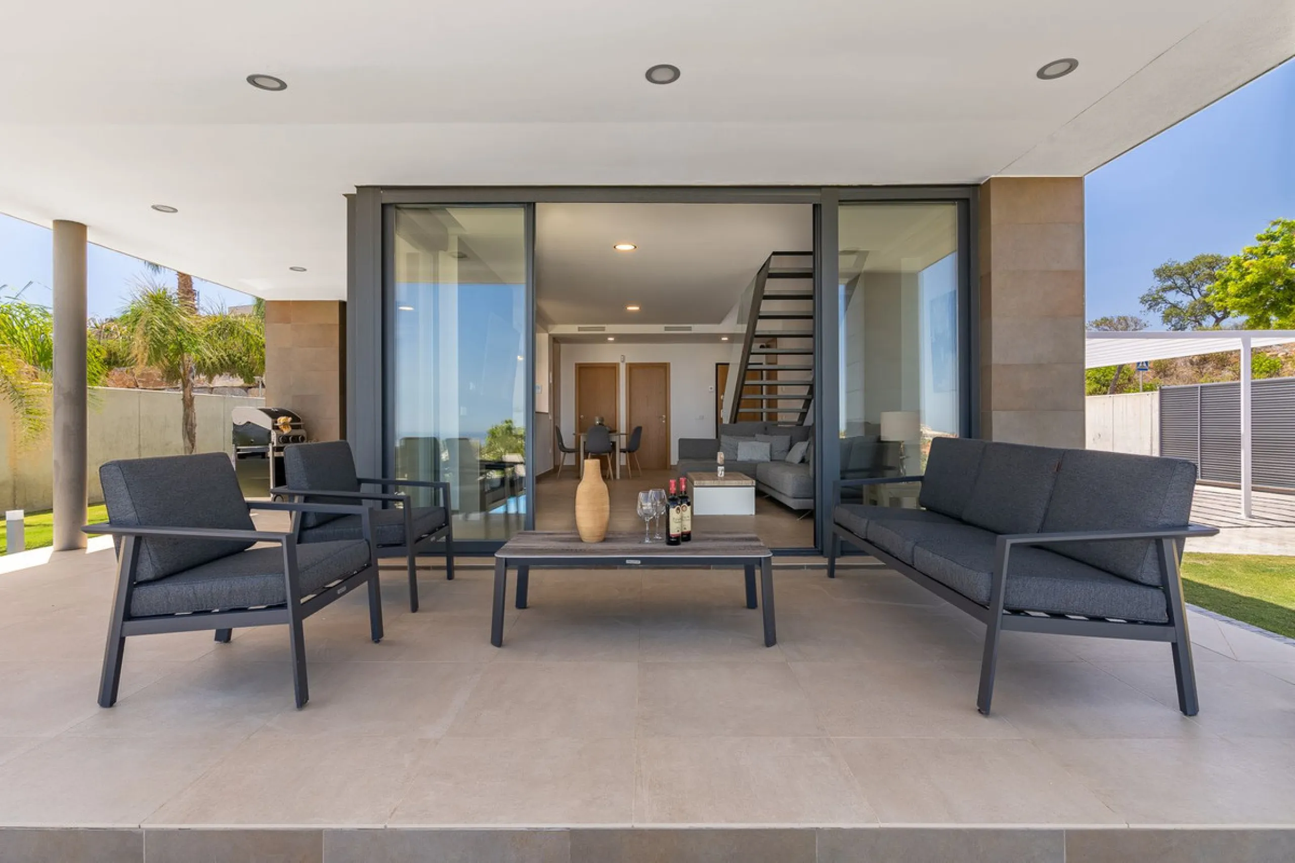 This stunning two-story villa boasts four spacious bedrooms, each with fitted wardrobes, electric blinds, and individual air conditioning control. The three elegant bathrooms feature the comfort of underfloor heating.