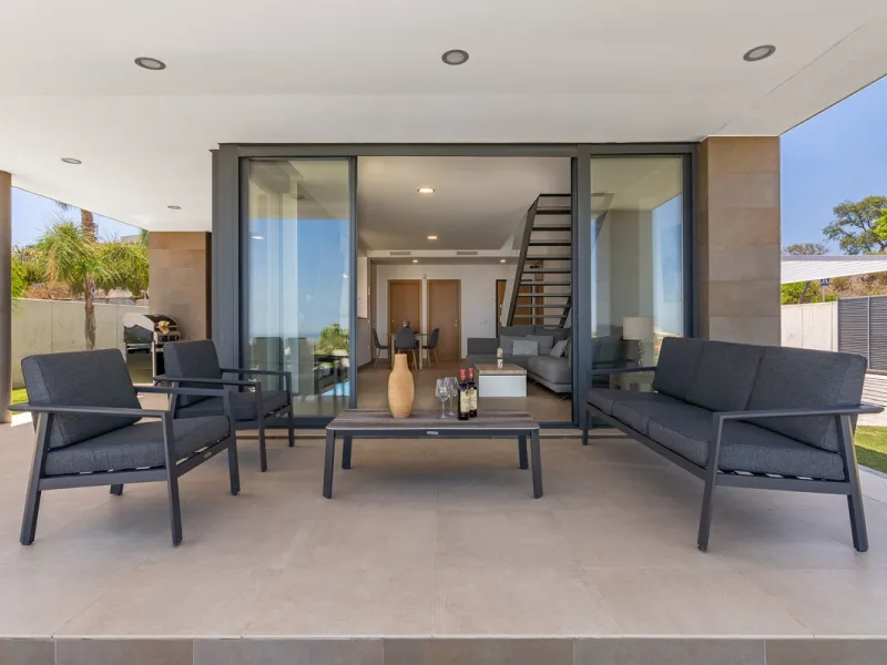 This stunning two-story villa boasts four spacious bedrooms, each with fitted wardrobes, electric blinds, and individual air conditioning control. The three elegant bathrooms feature the comfort of underfloor heating.