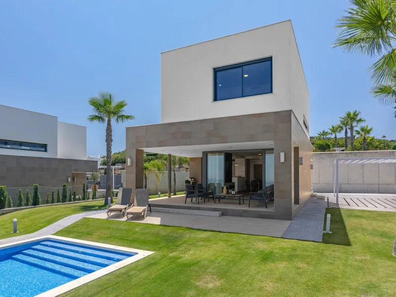 This stunning two-story villa boasts four spacious bedrooms, each with fitted wardrobes, electric blinds, and individual air conditioning control. The three elegant bathrooms feature the comfort of underfloor heating.