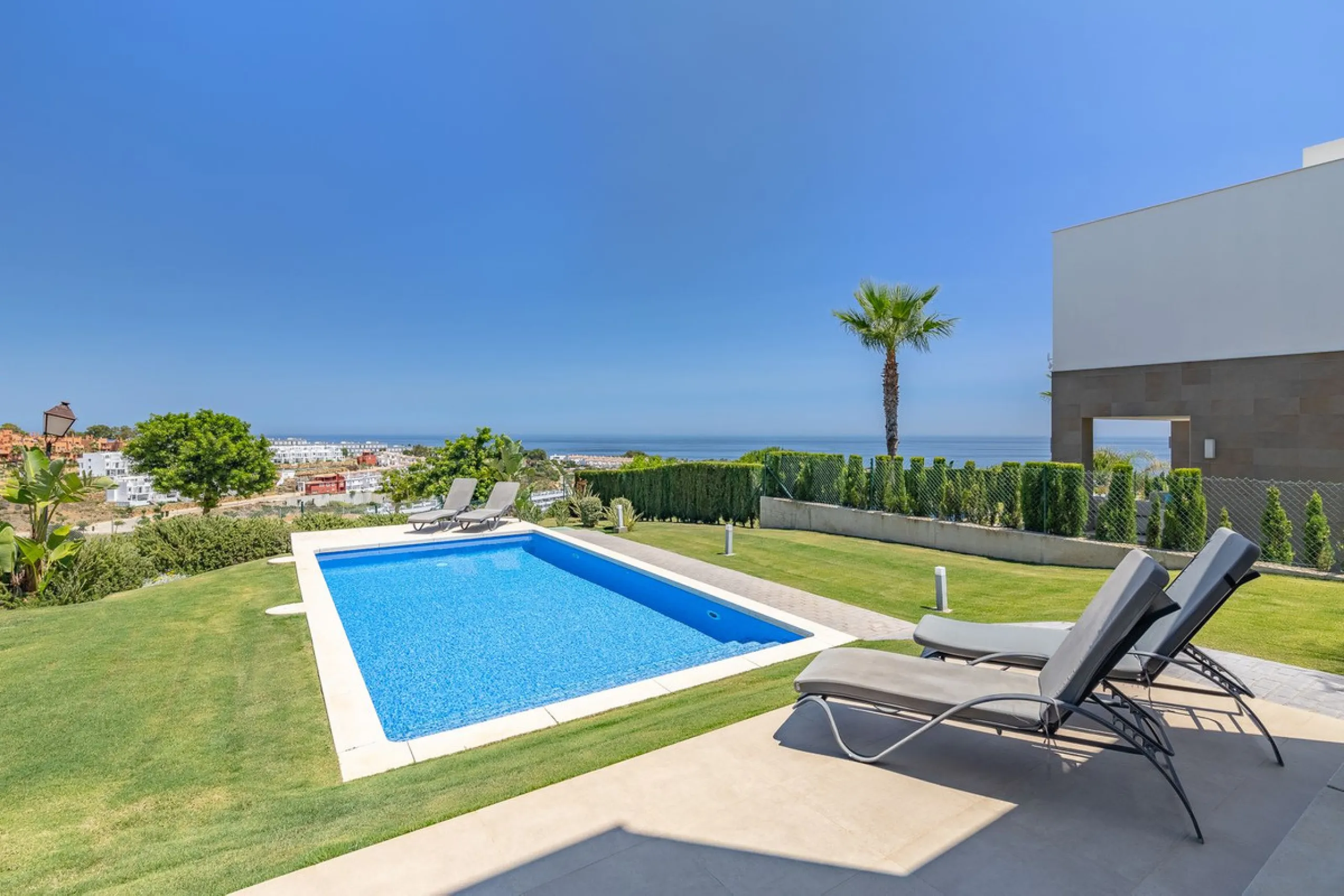 This stunning two-story villa boasts four spacious bedrooms, each with fitted wardrobes, electric blinds, and individual air conditioning control. The three elegant bathrooms feature the comfort of underfloor heating.