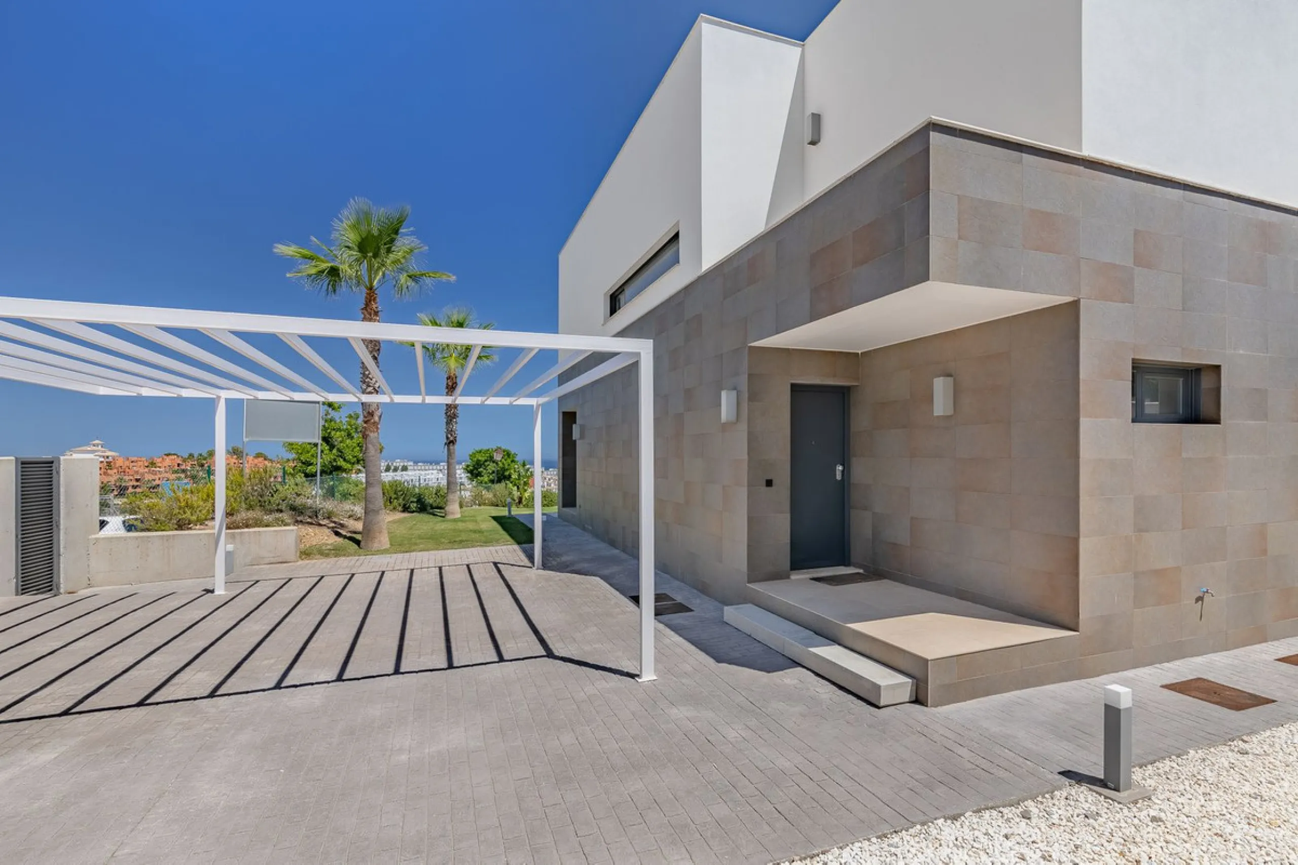 This stunning two-story villa boasts four spacious bedrooms, each with fitted wardrobes, electric blinds, and individual air conditioning control. The three elegant bathrooms feature the comfort of underfloor heating.