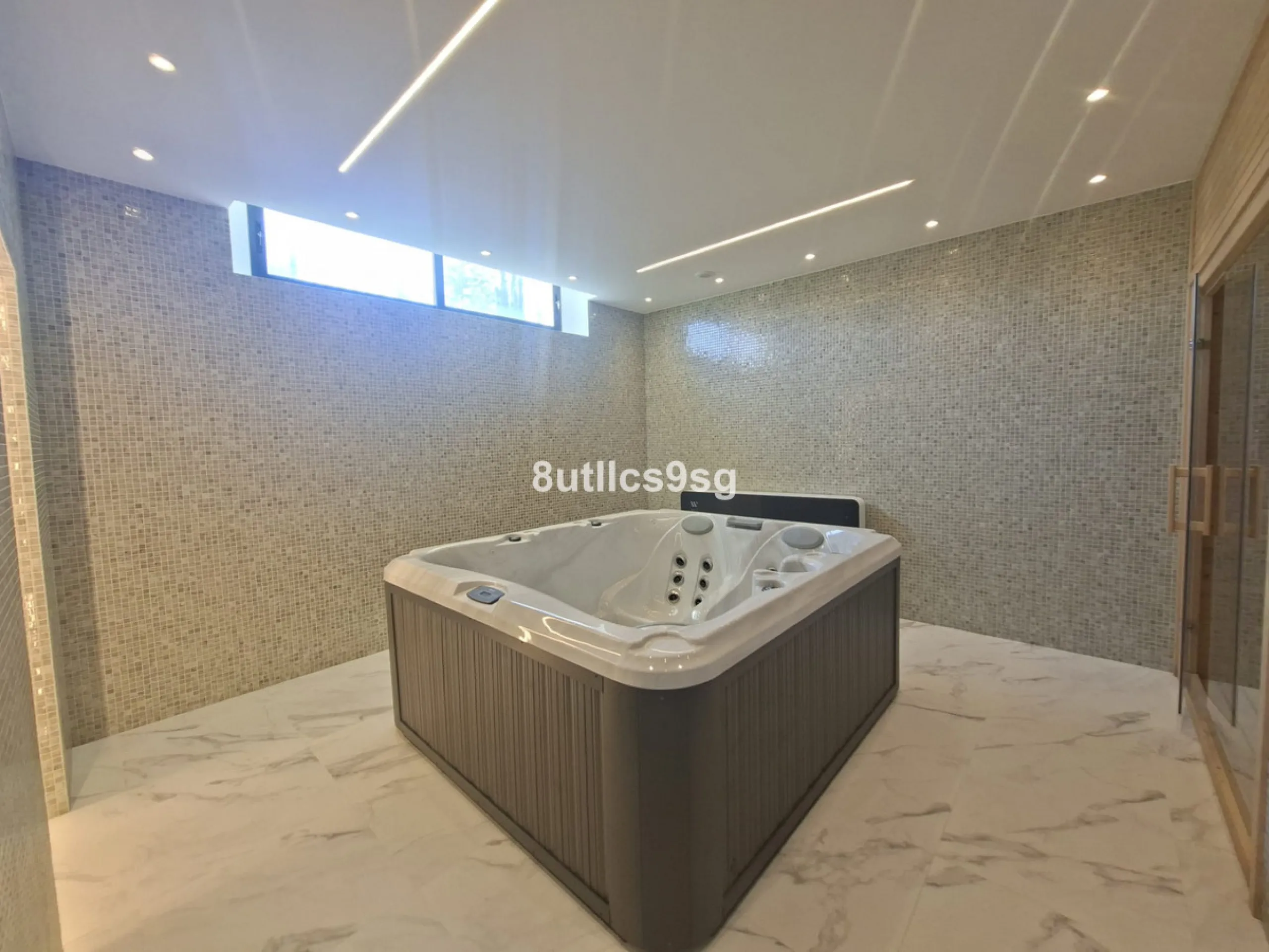 This contemporary villa is situated in the sought-after area of Paraiso Alto, Benahavis, Malaga. The property offers six bedrooms and eight bathrooms, including six en-suite, and stands out for its generous proportions with a built area of 1,038m² and a p