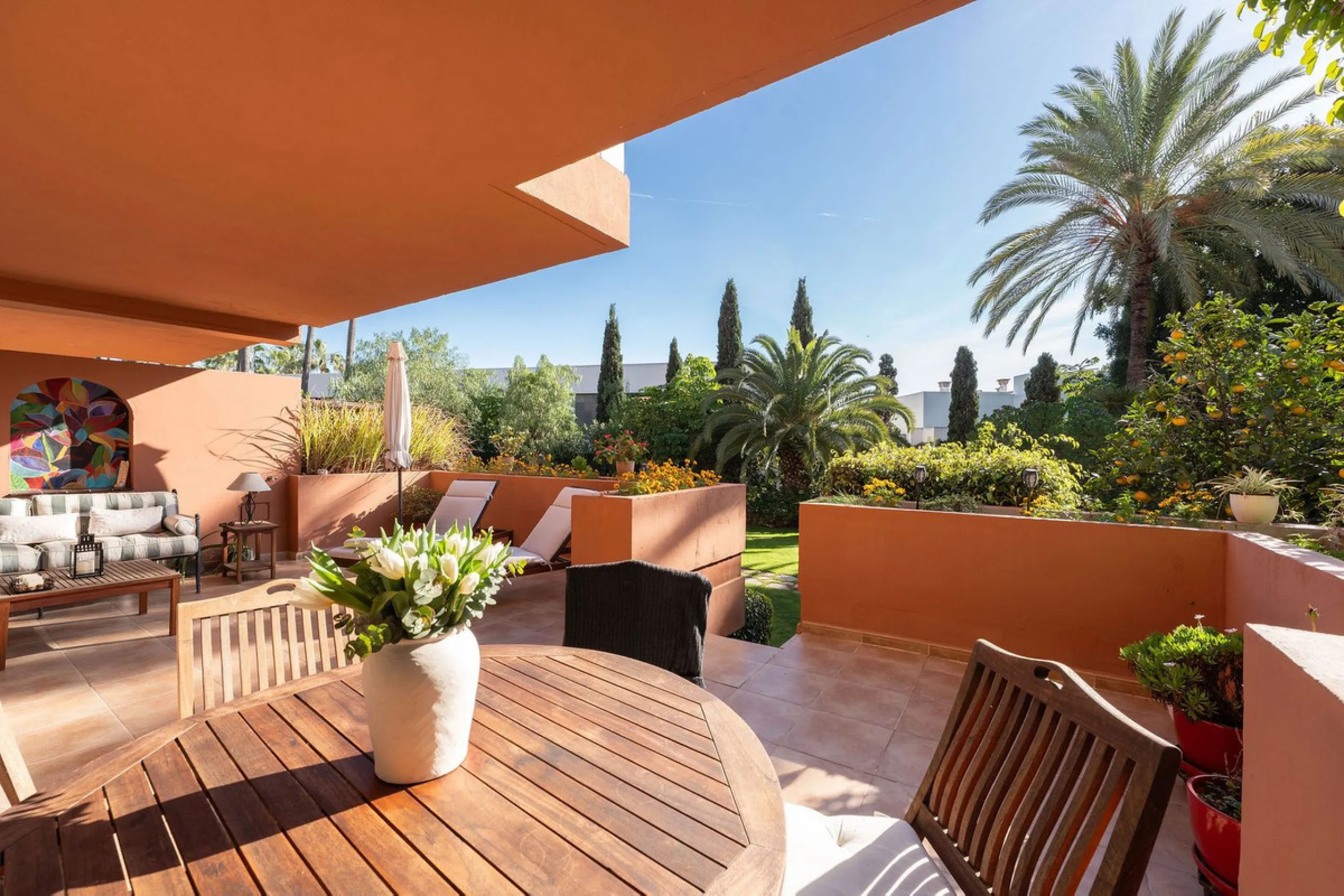 Just a short walk from the beach, this spacious two-bedroom apartment offers direct access to the beautifully maintained garden and swimming pool via a wide private terrace.