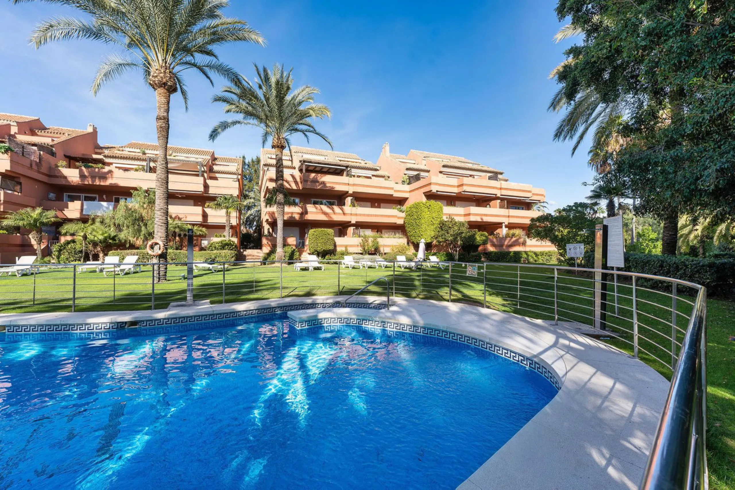 Just a short walk from the beach, this spacious two-bedroom apartment offers direct access to the beautifully maintained garden and swimming pool via a wide private terrace.