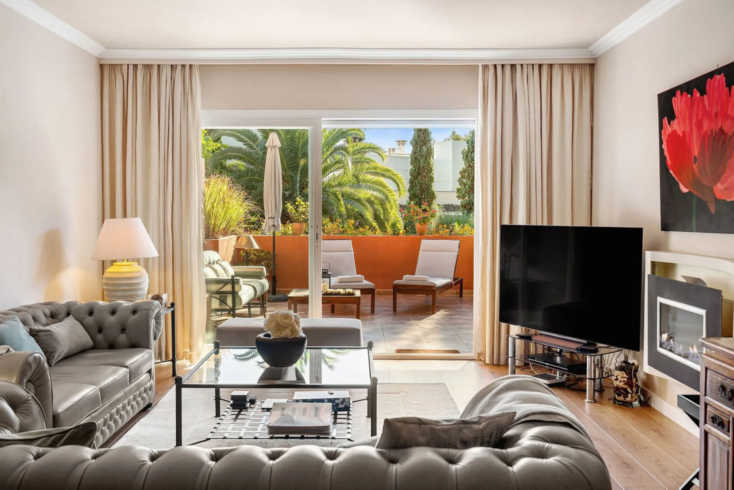 Just a short walk from the beach, this spacious two-bedroom apartment offers direct access to the beautifully maintained garden and swimming pool via a wide private terrace.