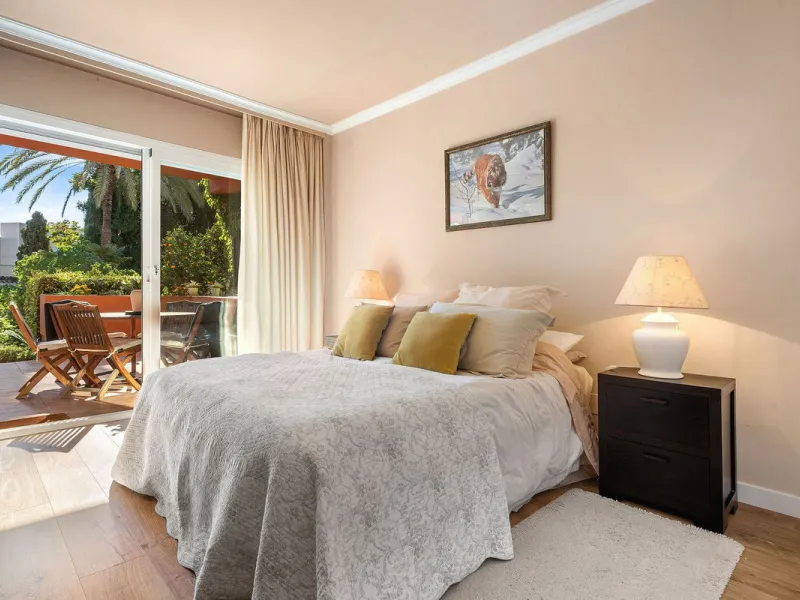 Just a short walk from the beach, this spacious two-bedroom apartment offers direct access to the beautifully maintained garden and swimming pool via a wide private terrace.