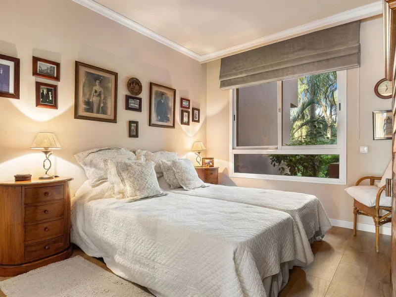 Just a short walk from the beach, this spacious two-bedroom apartment offers direct access to the beautifully maintained garden and swimming pool via a wide private terrace.