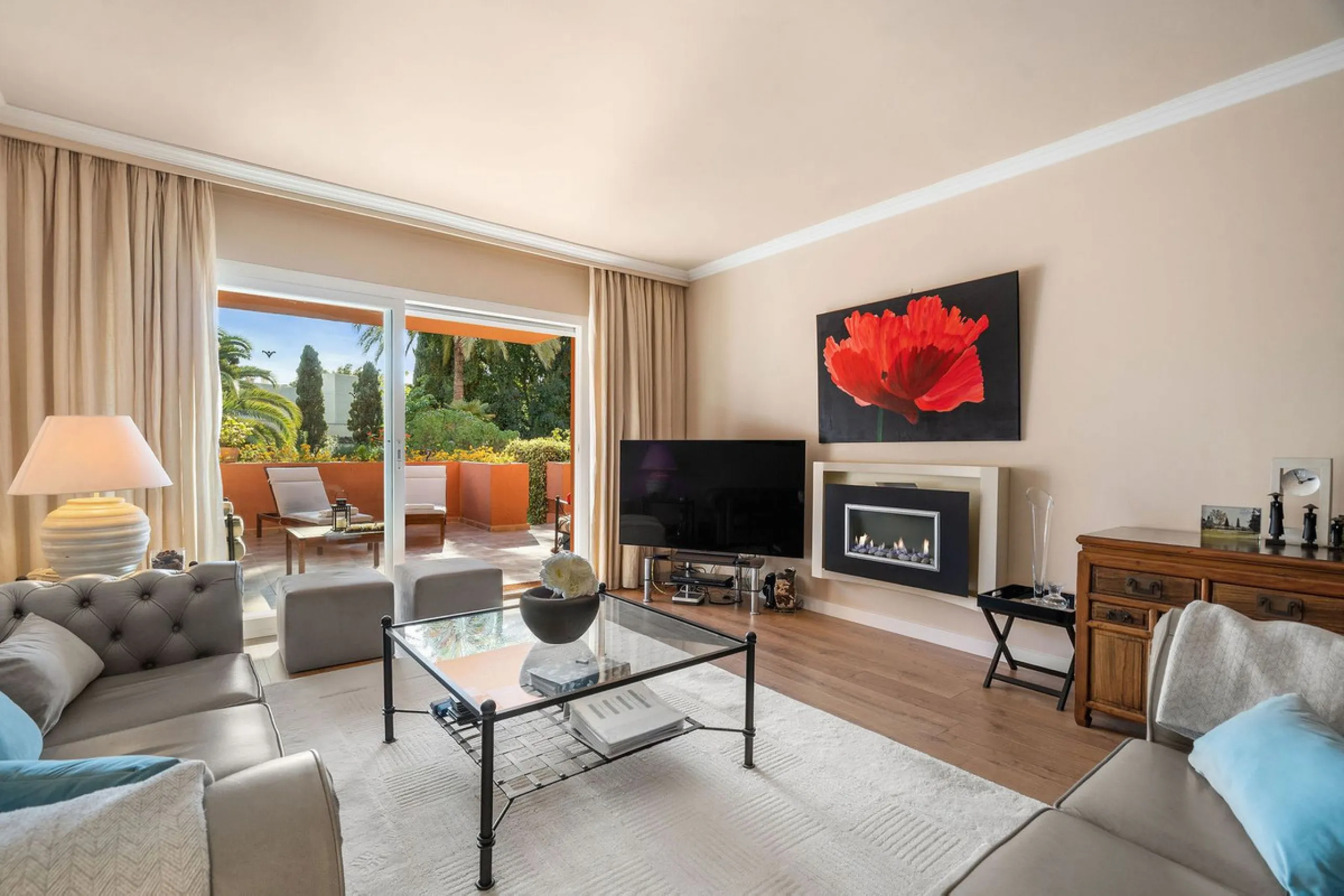 Just a short walk from the beach, this spacious two-bedroom apartment offers direct access to the beautifully maintained garden and swimming pool via a wide private terrace.
