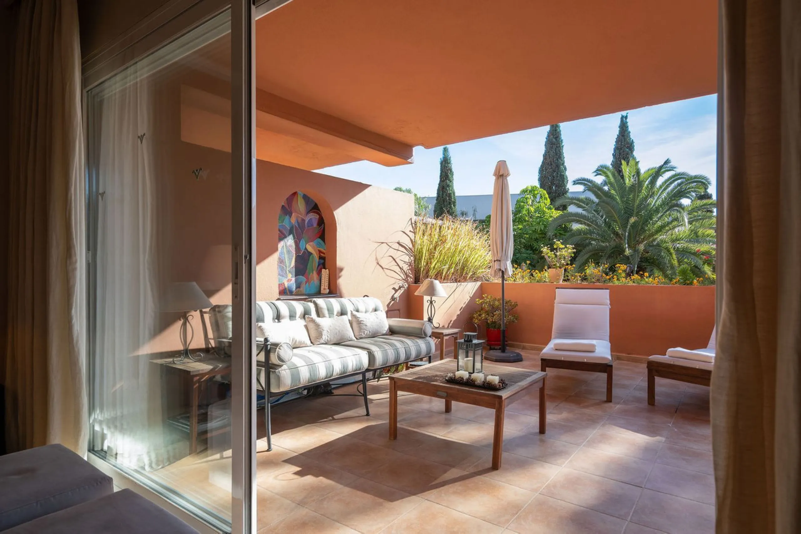 Just a short walk from the beach, this spacious two-bedroom apartment offers direct access to the beautifully maintained garden and swimming pool via a wide private terrace.