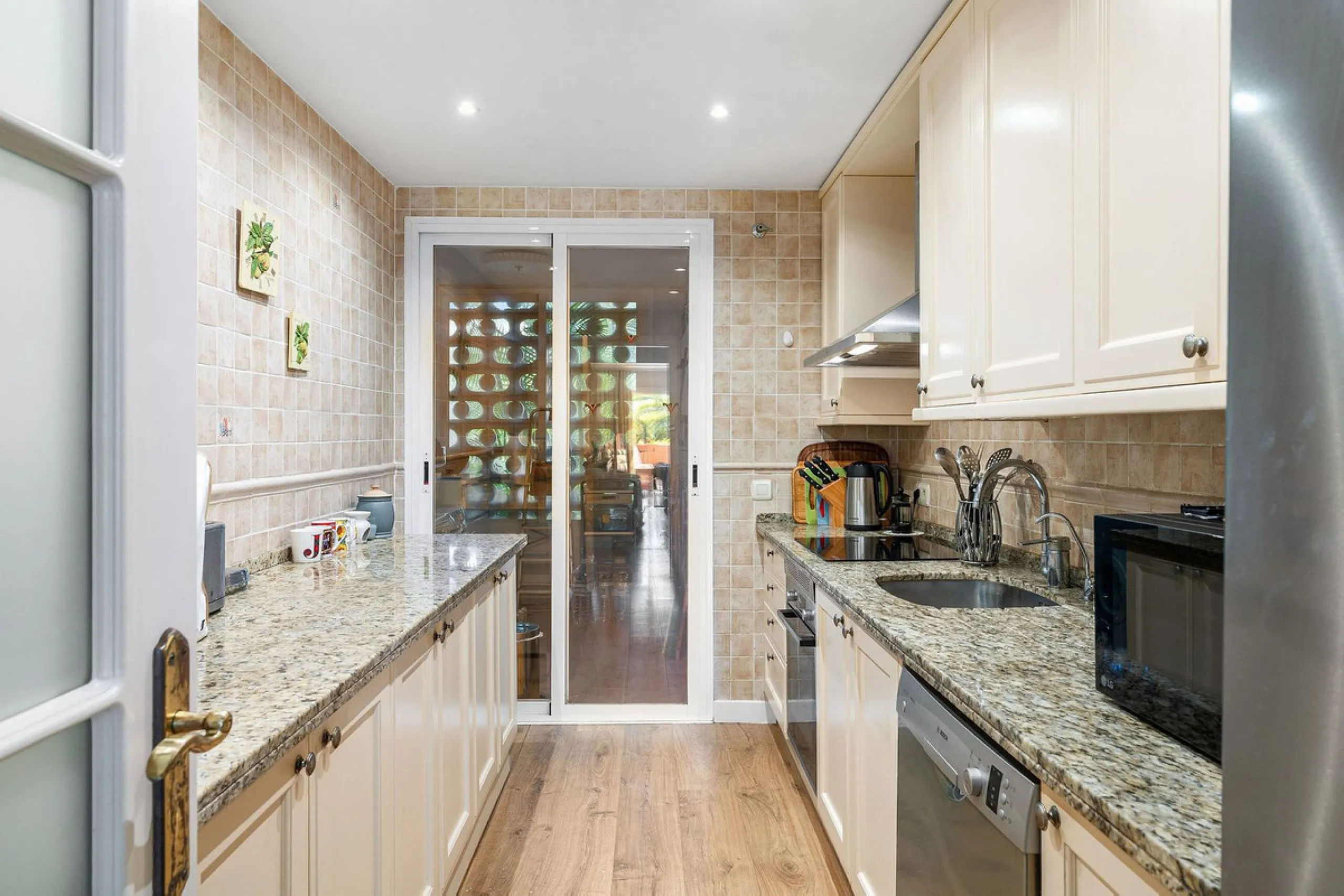 Just a short walk from the beach, this spacious two-bedroom apartment offers direct access to the beautifully maintained garden and swimming pool via a wide private terrace.