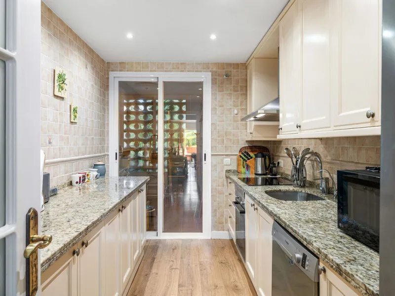 Just a short walk from the beach, this spacious two-bedroom apartment offers direct access to the beautifully maintained garden and swimming pool via a wide private terrace.