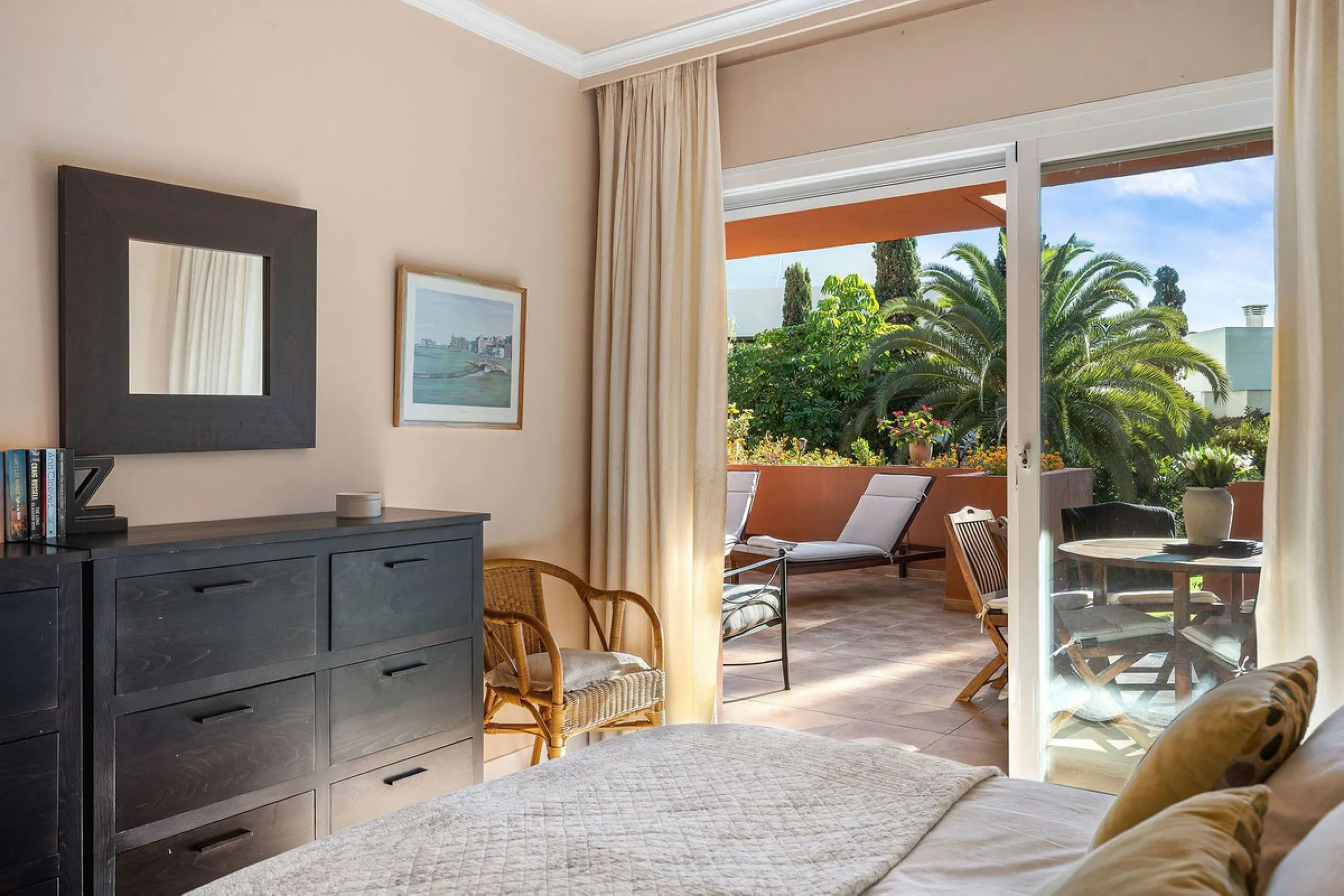 Just a short walk from the beach, this spacious two-bedroom apartment offers direct access to the beautifully maintained garden and swimming pool via a wide private terrace.