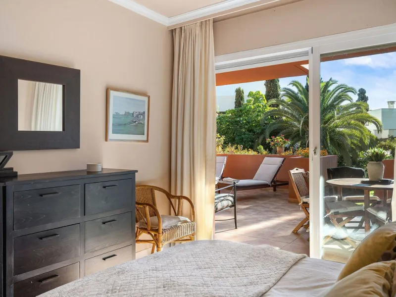 Just a short walk from the beach, this spacious two-bedroom apartment offers direct access to the beautifully maintained garden and swimming pool via a wide private terrace.