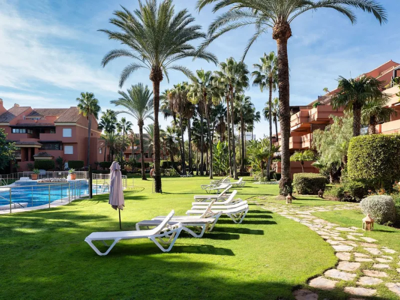 Just a short walk from the beach, this spacious two-bedroom apartment offers direct access to the beautifully maintained garden and swimming pool via a wide private terrace.