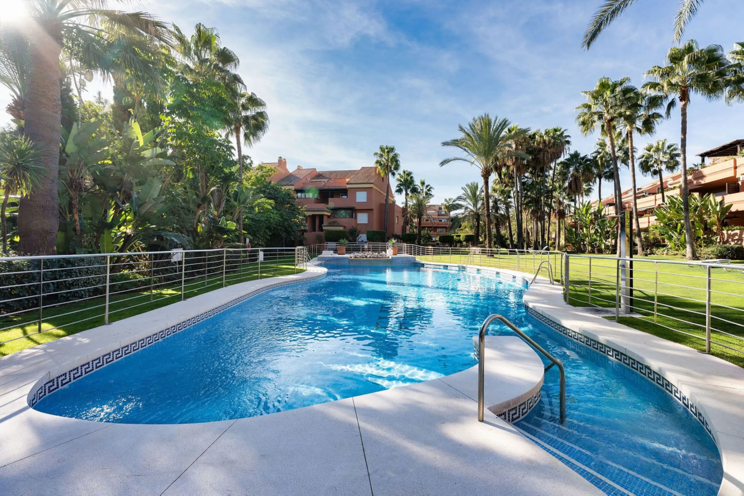 Just a short walk from the beach, this spacious two-bedroom apartment offers direct access to the beautifully maintained garden and swimming pool via a wide private terrace.