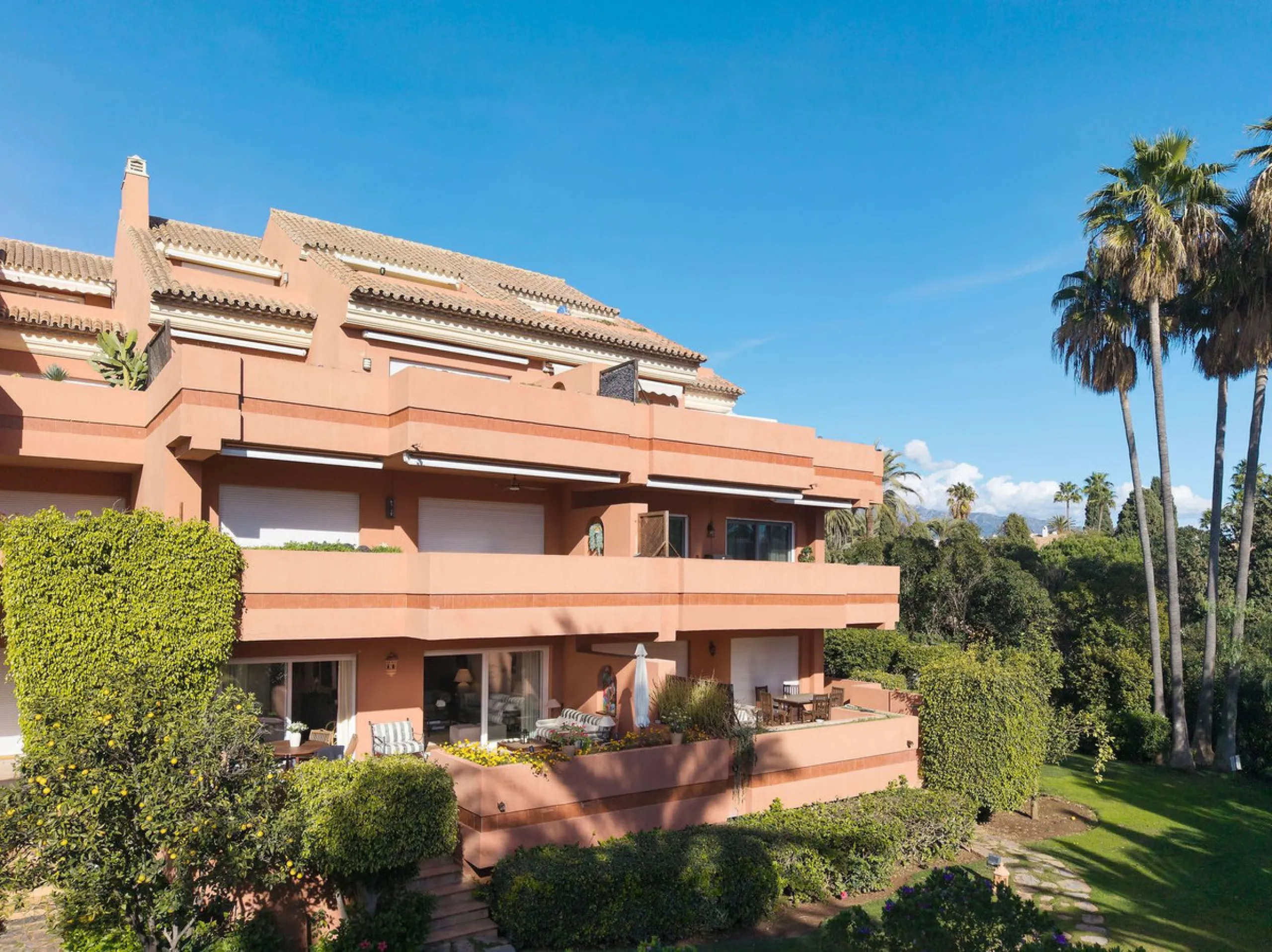 Just a short walk from the beach, this spacious two-bedroom apartment offers direct access to the beautifully maintained garden and swimming pool via a wide private terrace.