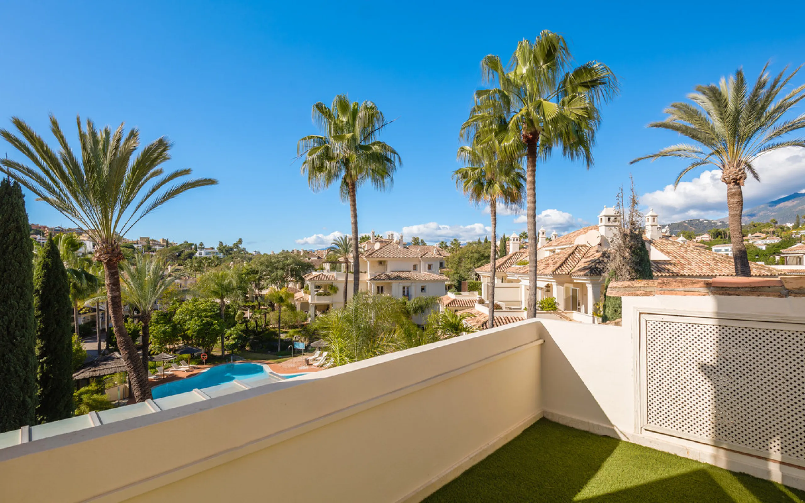This exceptional and exquisitely designed southwest-facing duplex penthouse offers a stunning panoramic view of the award-winning gardens of Las Alamandas, in Nueva Andalucía, providing an ideal balance of sun and shade across its expansive terrace spaces