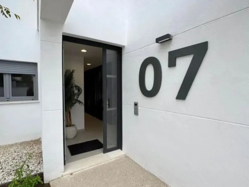 This bright, unfurnished 2-bedroom apartment pairs a practical layout with a calm outlook over the green communal landscape and a distant sea view from the terrace.