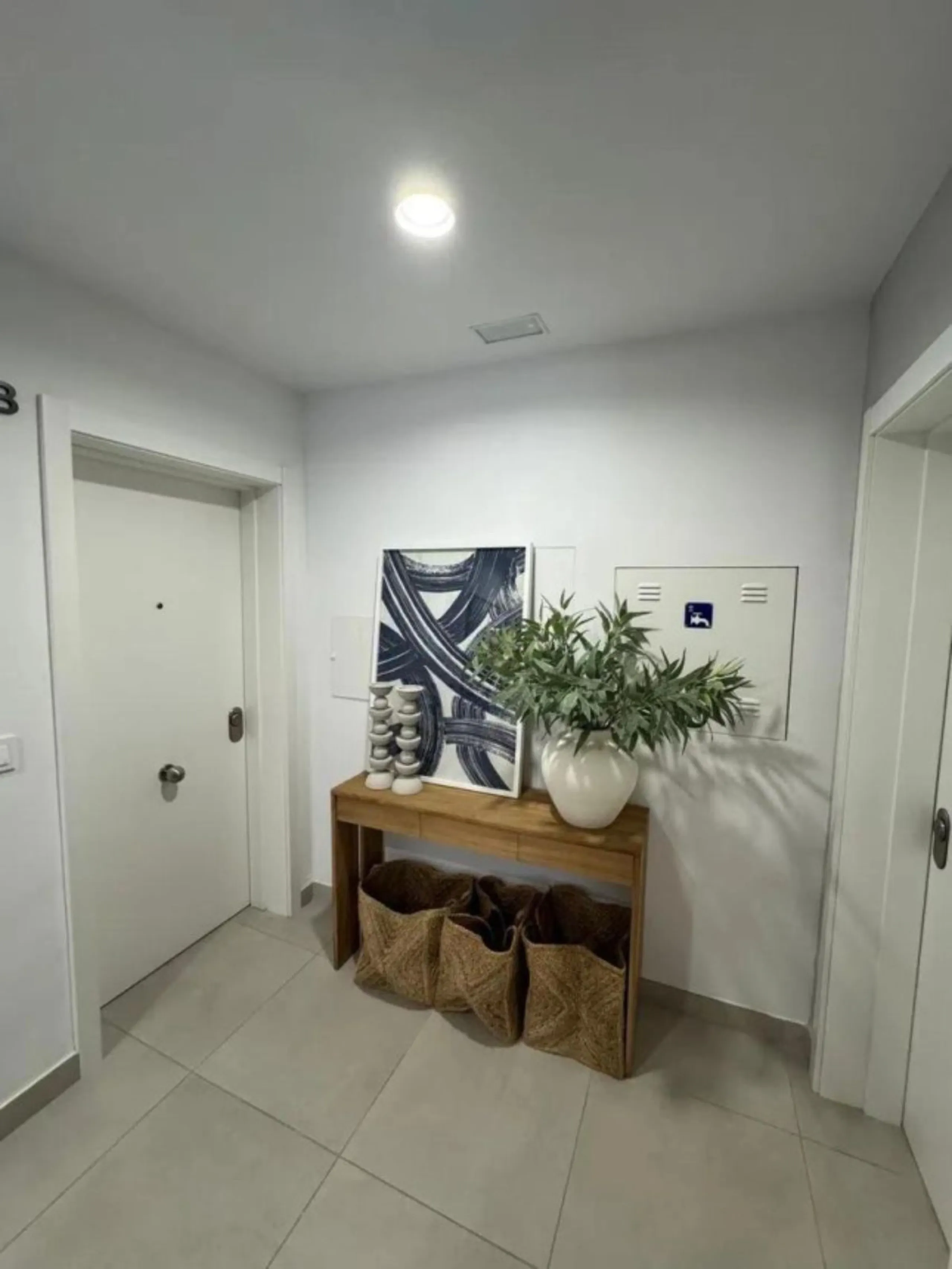 This bright, unfurnished 2-bedroom apartment pairs a practical layout with a calm outlook over the green communal landscape and a distant sea view from the terrace.